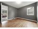 Neutral room with hardwood floors, a window, and an open doorway at 2925 S Harrison St, Denver, CO 80210