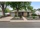 Inviting single-story home featuring a landscaped front yard, attached garage, and cozy front porch at 2925 S Harrison St, Denver, CO 80210
