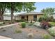 Beautiful single-story home with lush front garden, mature tree, and a stone pathway to the entrance at 2925 S Harrison St, Denver, CO 80210