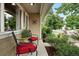 Cozy front porch with comfortable seating and views of the landscaped front yard and neighborhood at 2925 S Harrison St, Denver, CO 80210