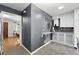 Charming kitchen features grey walls, white cabinets, granite countertops, and a unique wall-mounted marble shelf at 2925 S Harrison St, Denver, CO 80210