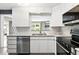 Bright kitchen with granite countertops, stainless appliances, and ample cabinet space at 2925 S Harrison St, Denver, CO 80210