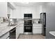 Well-lit kitchen with sleek appliances, white cabinetry, and granite counters for a modern feel at 2925 S Harrison St, Denver, CO 80210