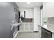 Bright kitchen features white cabinets, granite countertops, and a unique wall-mounted marble shelf at 2925 S Harrison St, Denver, CO 80210