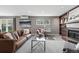 Bright living room with hardwood floors, modern decor, and a brick fireplace with shelving at 2925 S Harrison St, Denver, CO 80210