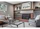 Relaxing living room with stylish decor, including brick fireplace and built-in bookshelves at 2925 S Harrison St, Denver, CO 80210