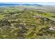 Sweeping aerial perspective of sprawling land featuring rolling hills, scattered homes, and scenic vistas at 2938 Wolfensberger Rd, Sedalia, CO 80135