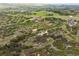 Picturesque aerial view highlighting vast land with varied topography, scattered buildings, and natural beauty at 2938 Wolfensberger Rd, Sedalia, CO 80135