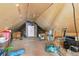Spacious attic space with sloped ceilings, miscellaneous furnishings, and multiple windows at 2938 Wolfensberger Rd, Sedalia, CO 80135