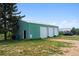 Large barn with multiple doors providing ample space for storage and hobbies at 2938 Wolfensberger Rd, Sedalia, CO 80135