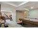 Finished basement with a pool table, storage, and workout equipment at 2938 Wolfensberger Rd, Sedalia, CO 80135