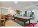 Finished basement with a pool table, chairs, and workout equipment at 2938 Wolfensberger Rd, Sedalia, CO 80135