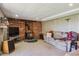 Finished basement Gathering room with wood burning stove and brick accent wall at 2938 Wolfensberger Rd, Sedalia, CO 80135