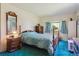 Spacious bedroom featuring a four-poster bed, carpeted floor, and large window at 2938 Wolfensberger Rd, Sedalia, CO 80135
