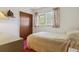 Cozy bedroom with a full bed, simple decor, and natural light from the window at 2938 Wolfensberger Rd, Sedalia, CO 80135