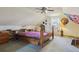 Finished attic bedroom with sloped ceilings, ceiling fan, wood-frame bed, and built in shelves at 2938 Wolfensberger Rd, Sedalia, CO 80135
