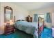Comfortable bedroom with a bed and vintage mirror and bay window at 2938 Wolfensberger Rd, Sedalia, CO 80135