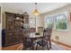 Charming dining room featuring a wooden table set, a vintage china cabinet, and natural light at 2938 Wolfensberger Rd, Sedalia, CO 80135