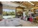 Open garage with exposed wooden beams, shelving, and lots of storage space at 2938 Wolfensberger Rd, Sedalia, CO 80135