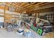 Spacious garage featuring ample storage, tools, equipment, and a Bobcat at 2938 Wolfensberger Rd, Sedalia, CO 80135