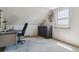 Attic office space with sloped ceilings, window, black cabinet, a black desk and chair at 2938 Wolfensberger Rd, Sedalia, CO 80135