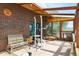 Spacious sunroom featuring brick accents and a wood ceiling at 2938 Wolfensberger Rd, Sedalia, CO 80135