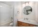 Clean bathroom with shower-tub combo, tile surround, and wood vanity at 6617 S Forest Way # E, Centennial, CO 80121