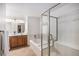 Bathroom featuring a soaking tub and tiled shower with glass door at 6617 S Forest Way # E, Centennial, CO 80121