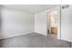 Spacious bedroom showcasing neutral carpet and an ensuite bathroom at 6617 S Forest Way # E, Centennial, CO 80121