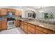 Well-equipped kitchen with stainless steel appliances, oak cabinets and granite counters at 6617 S Forest Way # E, Centennial, CO 80121