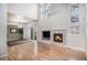 Bright living room with hardwood floors, fireplace, and large windows at 6617 S Forest Way # E, Centennial, CO 80121