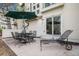 Outdoor patio features metal furniture, including table, chairs, and lounge, with a green umbrella at 6617 S Forest Way # E, Centennial, CO 80121