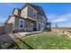 Spacious backyard featuring a covered patio, manicured lawn, and distant views at 3534 N Meadows Dr, Castle Rock, CO 80109
