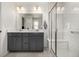Modern bathroom features double vanity, large mirror, and glass-enclosed shower with bench at 3534 N Meadows Dr, Castle Rock, CO 80109