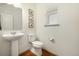 Simple half bath featuring a pedestal sink, modern fixtures, and a clean design at 3534 N Meadows Dr, Castle Rock, CO 80109