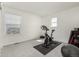 Bright bedroom featuring neutral carpet, complemented by exercise equipment and a large window at 3534 N Meadows Dr, Castle Rock, CO 80109