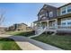 Two-story house featuring a welcoming front porch, showcasing a home's design and curb appeal at 3534 N Meadows Dr, Castle Rock, CO 80109