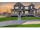 Attractive two-story home with a covered front porch and well-manicured lawn and landscaping at 3534 N Meadows Dr, Castle Rock, CO 80109