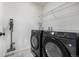 Laundry room with modern washer and dryer, plus convenient shelving for organization at 3534 N Meadows Dr, Castle Rock, CO 80109