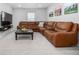 Cozy living room features an oversized sectional sofa, stylish coffee table, and wall-mounted TV at 3534 N Meadows Dr, Castle Rock, CO 80109