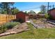 Backyard shed, garden with wildflowers, and walking path at 4530 S Inca St, Englewood, CO 80110