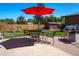 Outdoor patio with chairs, table and grill; features a grassy yard and wooden fence at 4530 S Inca St, Englewood, CO 80110