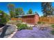 Backyard shed, garden with wildflowers, garden walking path, and wooden fence at 4530 S Inca St, Englewood, CO 80110