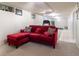Spacious basement with carpet, versatile workout space, and a comfortable red sectional couch at 4530 S Inca St, Englewood, CO 80110