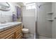 Bathroom with walk-in shower, tiled walls, and wooden vanity with sink at 4530 S Inca St, Englewood, CO 80110