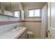 Well-maintained bathroom features classic tile work, a vanity, and a shower with a curtain at 4530 S Inca St, Englewood, CO 80110