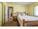 Cozy bedroom with a comfortable bed, natural light, and an open doorway to another room at 4530 S Inca St, Englewood, CO 80110