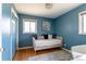 Stylish blue bedroom with hardwood floors, natural light, and a comfortable daybed at 4530 S Inca St, Englewood, CO 80110