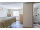 Bedroom with window, closet, and en suite bathroom with shower and tiled floors at 4530 S Inca St, Englewood, CO 80110