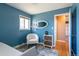 Bright bedroom with hardwood floors, a cozy chair, natural light, and ample closet space at 4530 S Inca St, Englewood, CO 80110